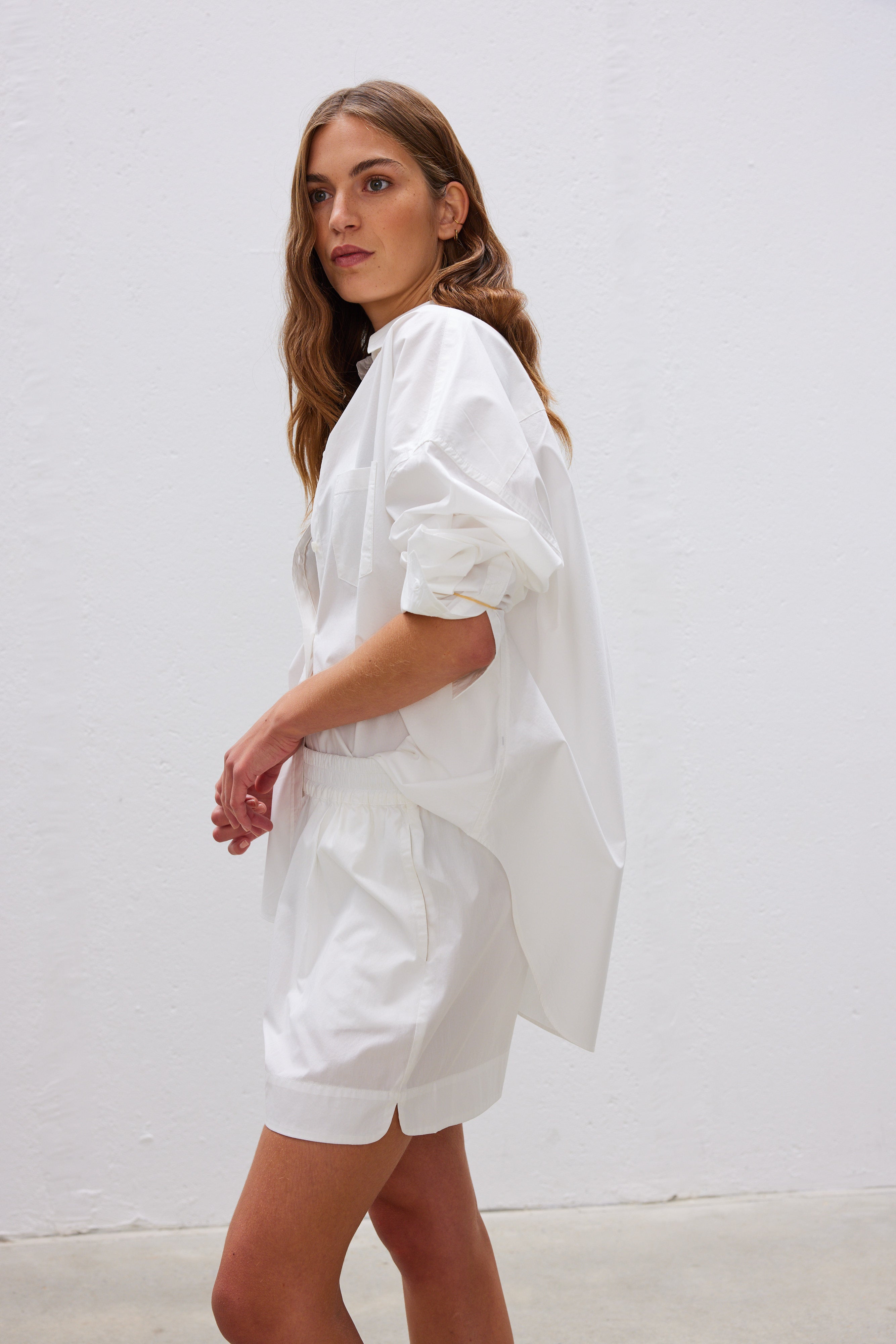  Classic white cotton shirt styled casually, showing versatile everyday wear