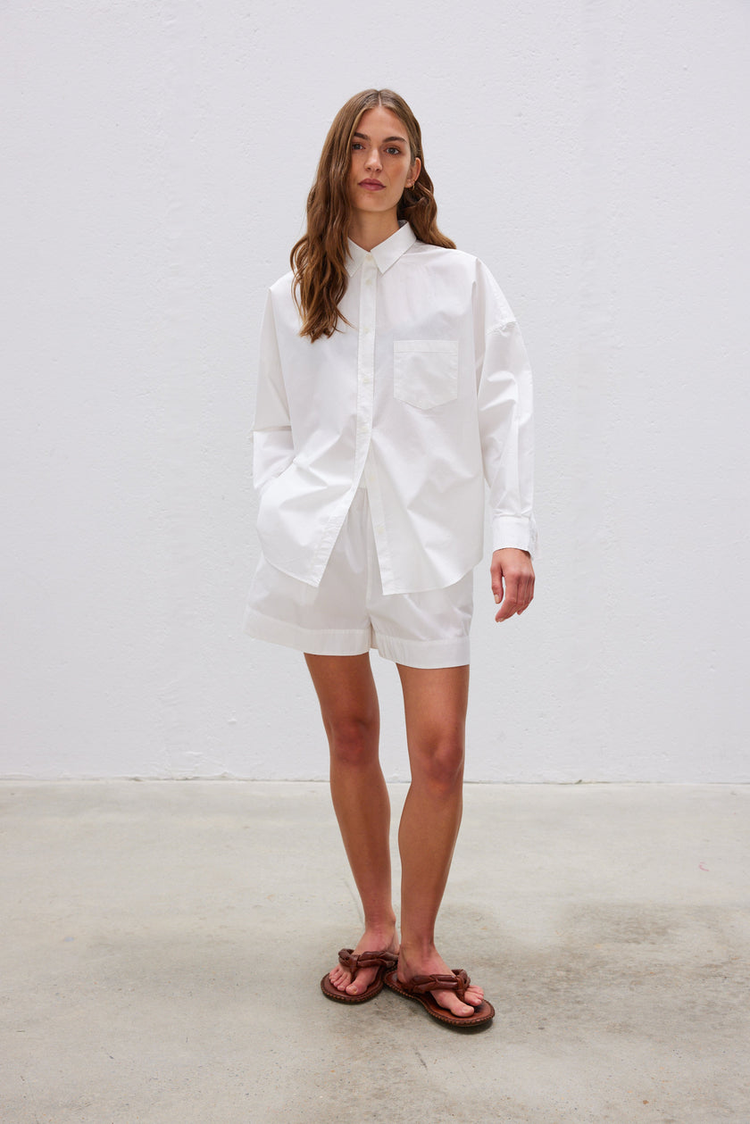  Classic white cotton shirt styled casually, showing versatile everyday wear