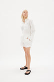 Classic white cotton shirt styled casually, showing versatile everyday wea