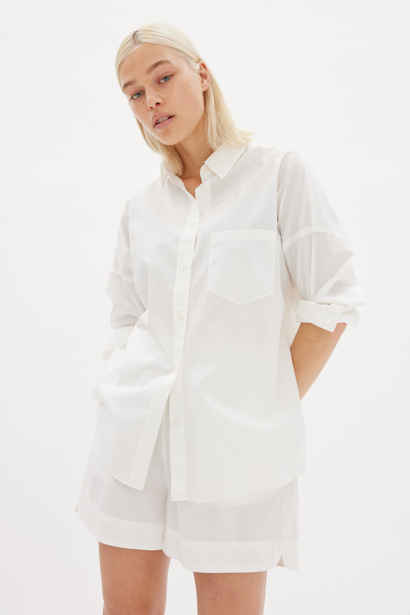 Classic white cotton shirt styled casually, showing versatile everyday wea