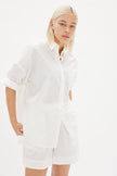  Classic white cotton shirt styled casually, showing versatile everyday wear