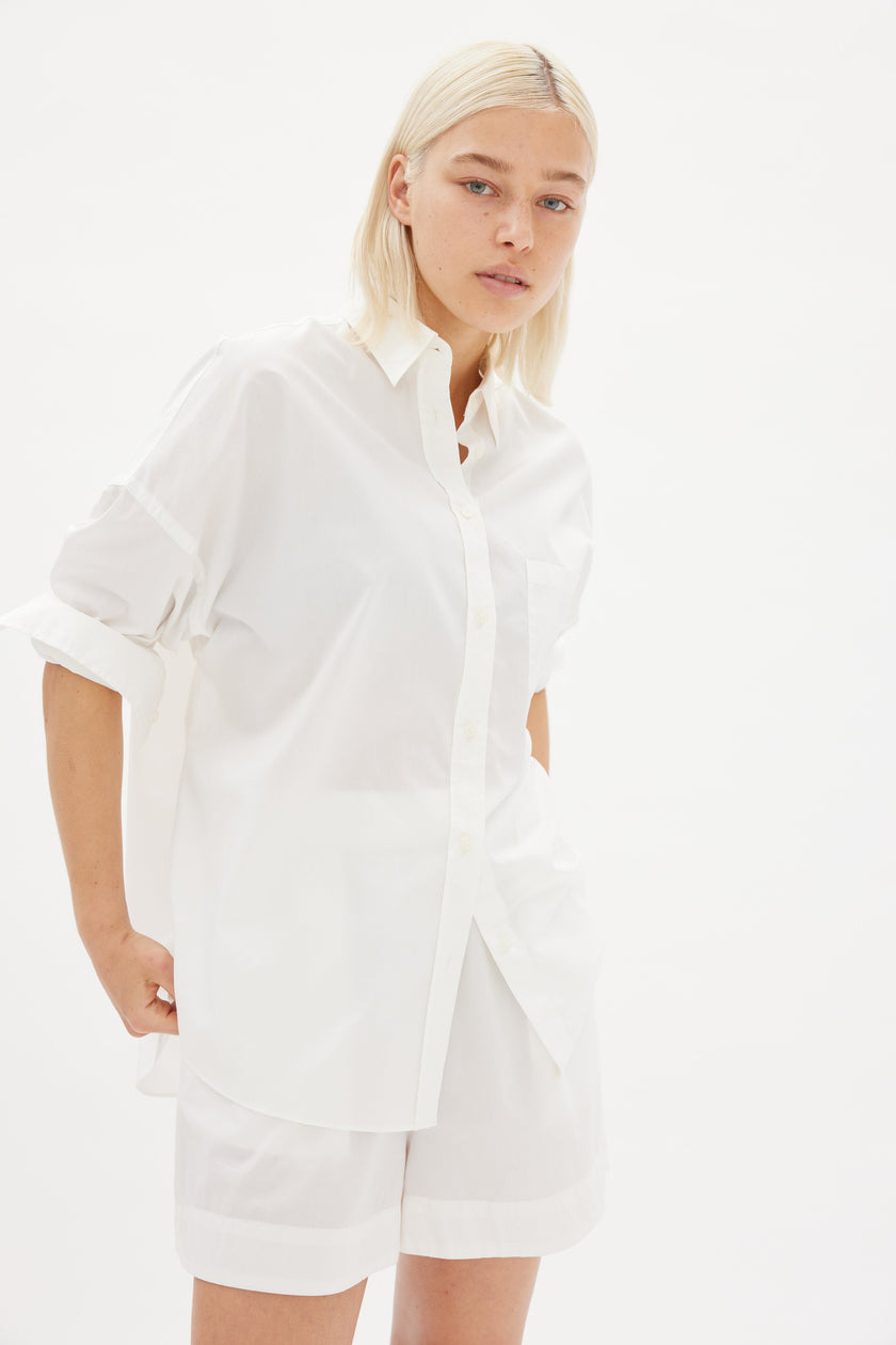  Classic white cotton shirt styled casually, showing versatile everyday wear