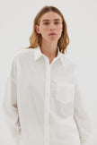 White cotton shirt front view showing relaxed fit and chest pocket detail