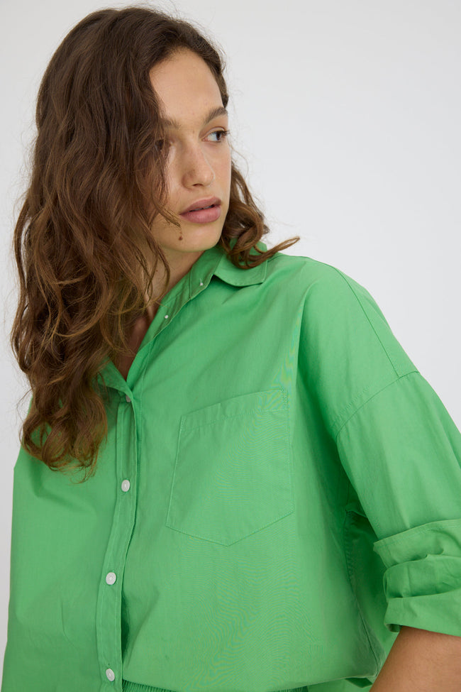 Light verde green cotton button-up shirt with relaxed fit and drop shoulders
